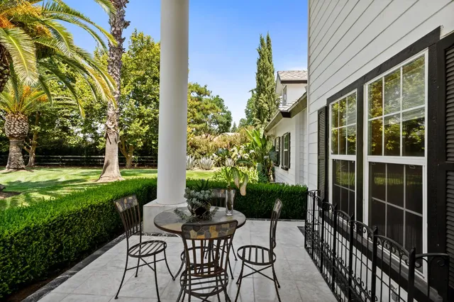 a living room with furniture piano and a window