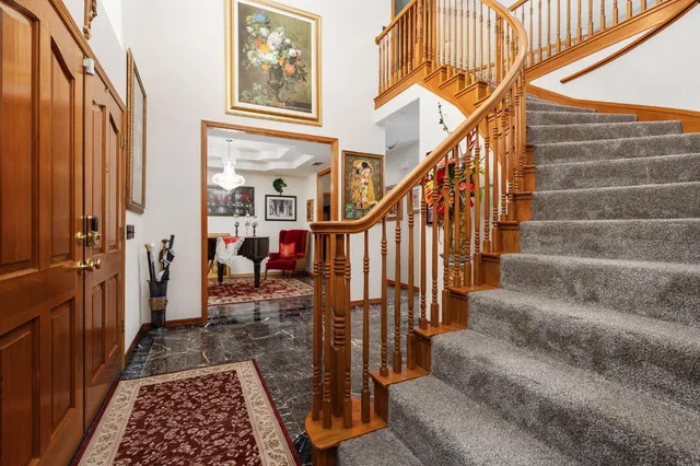 a living room with furniture a fireplace and a floor to ceiling window