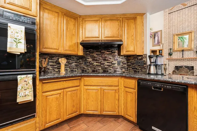 a palm tree sitting in a yard with swimming pool