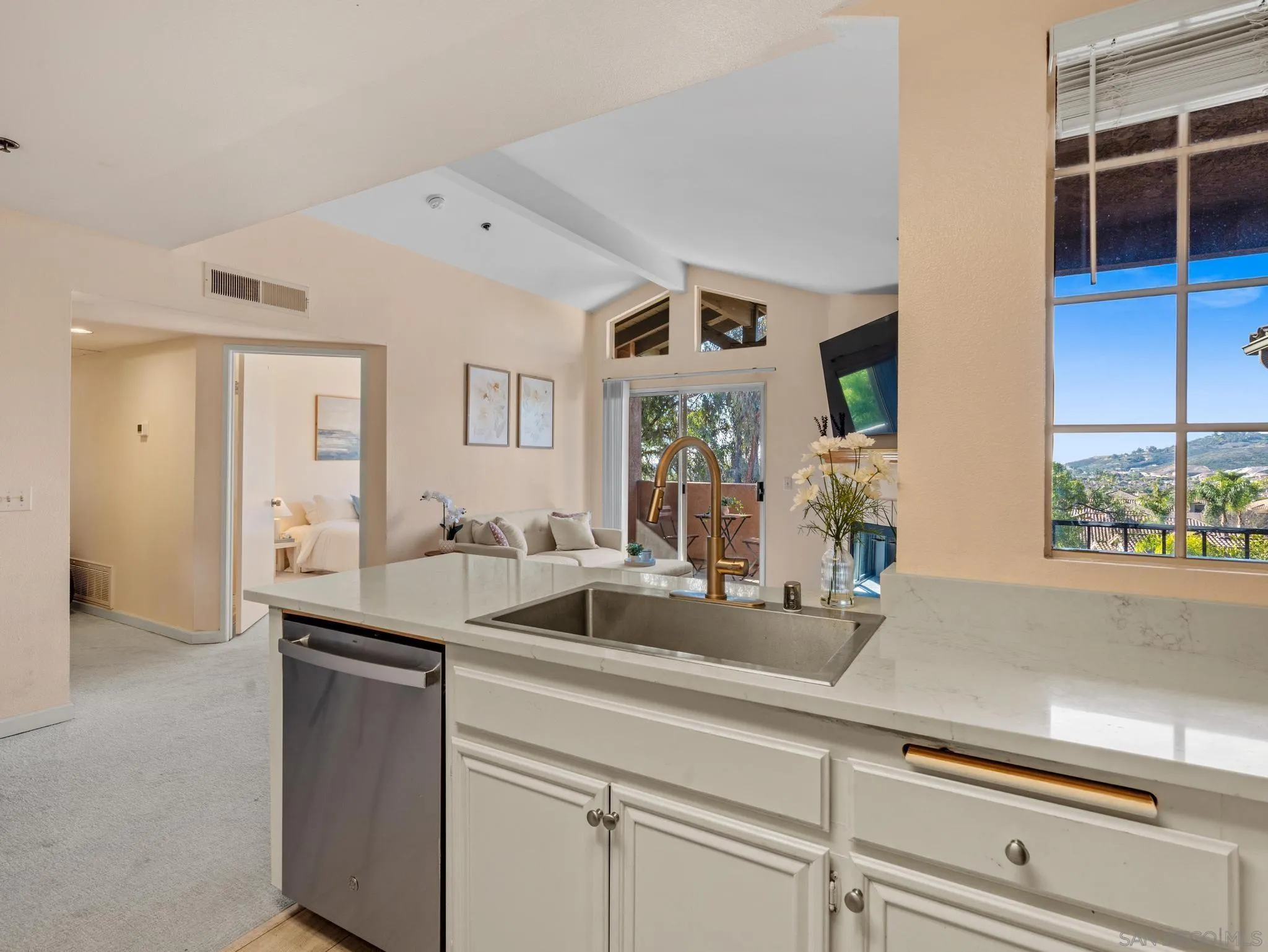 a kitchen with a sink and a mirror