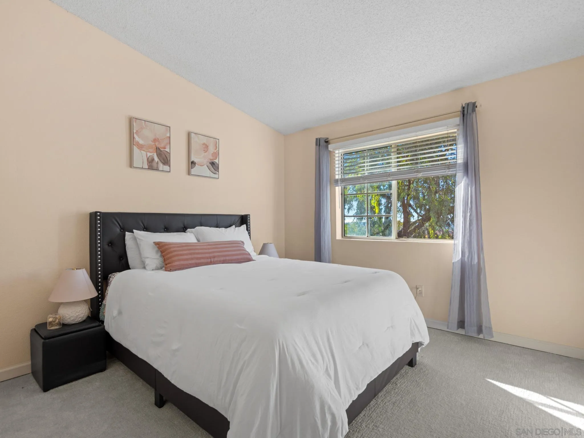 17161 Alva Road, Unit 2128 San Diego, CA 92127 - Photo 3 of 12 a large bed sitting in a bedroom next to a window