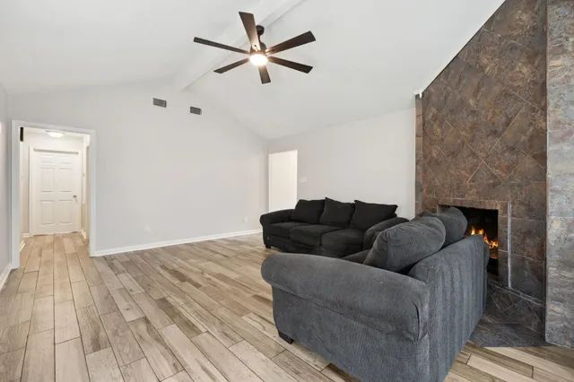 a living room with furniture and a fireplace