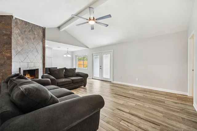 a living room with furniture and a ceiling fan