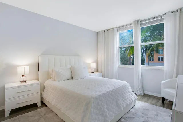 a bed room with a bed and a chair