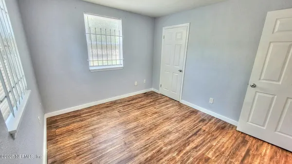 a view of a room with wooden floor and window