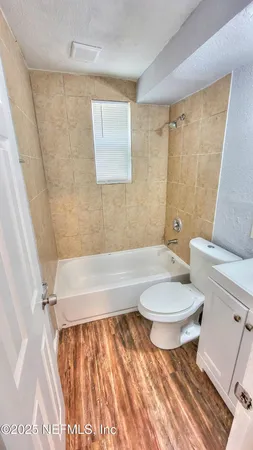a bathroom with a toilet a sink and bathtub