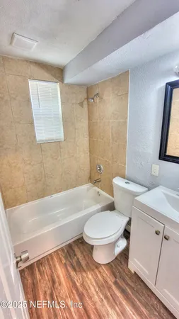 a bathroom with a toilet a sink and bathtub