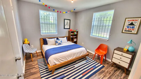 a bedroom with furniture and a window