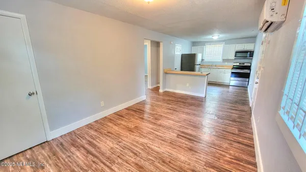 a view of kitchen and wooden floor