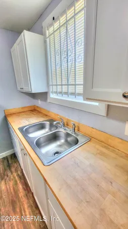 a view of a kitchen with a sink and large window