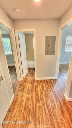 a view of an empty room and wooden floor