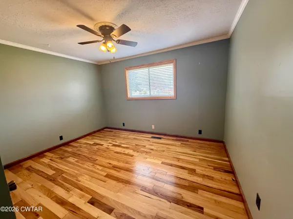 a view of a room with window and ceiling fan