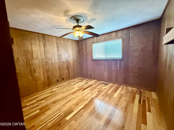 a bedroom with a bed and ceiling fan