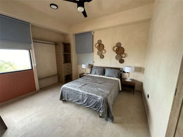 a bedroom with a bed and wall painting
