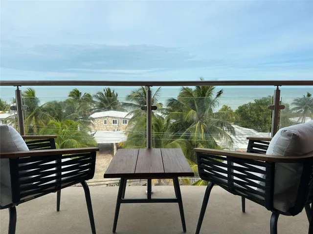 a view of a chairs and table in patio