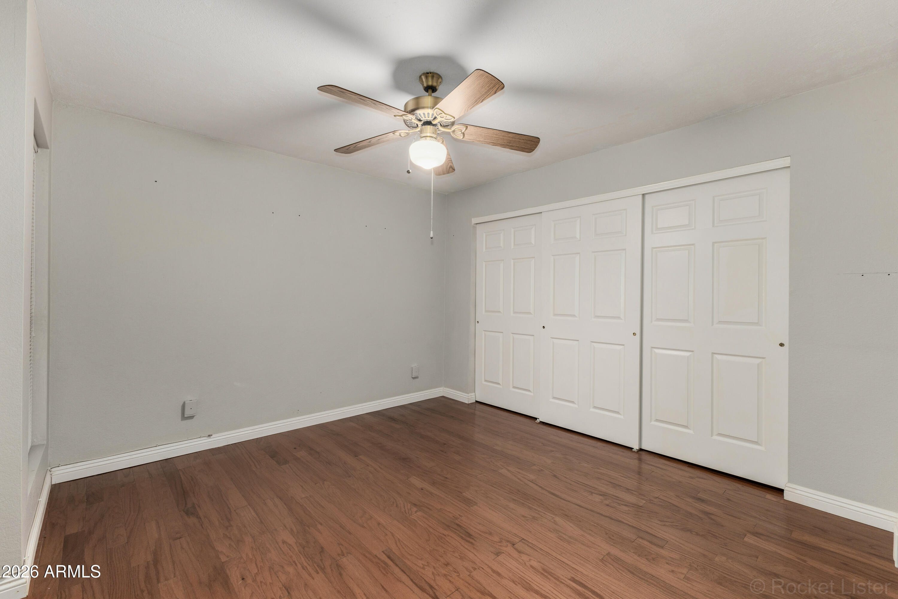 542 South Higley Road, Unit 61 Mesa, AZ 85206 - Photo 11 of 33 a view of an empty room with wooden floor