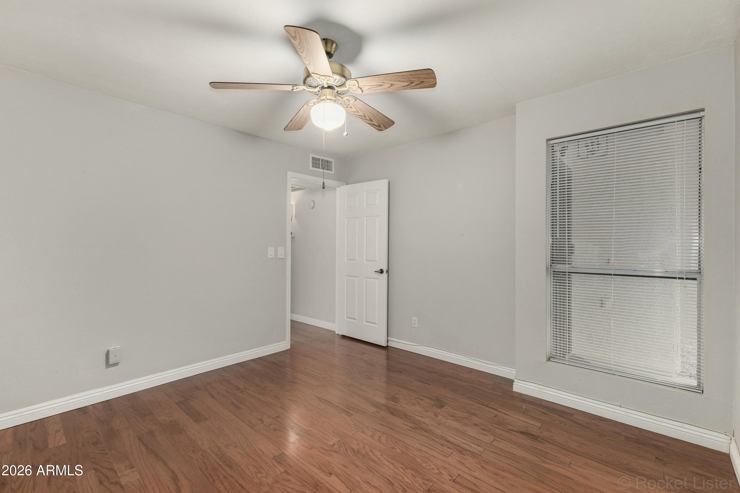 542 South Higley Road, Unit 61 Mesa, AZ 85206 - Photo 12 of 33 an empty room with wooden floor closet and fan