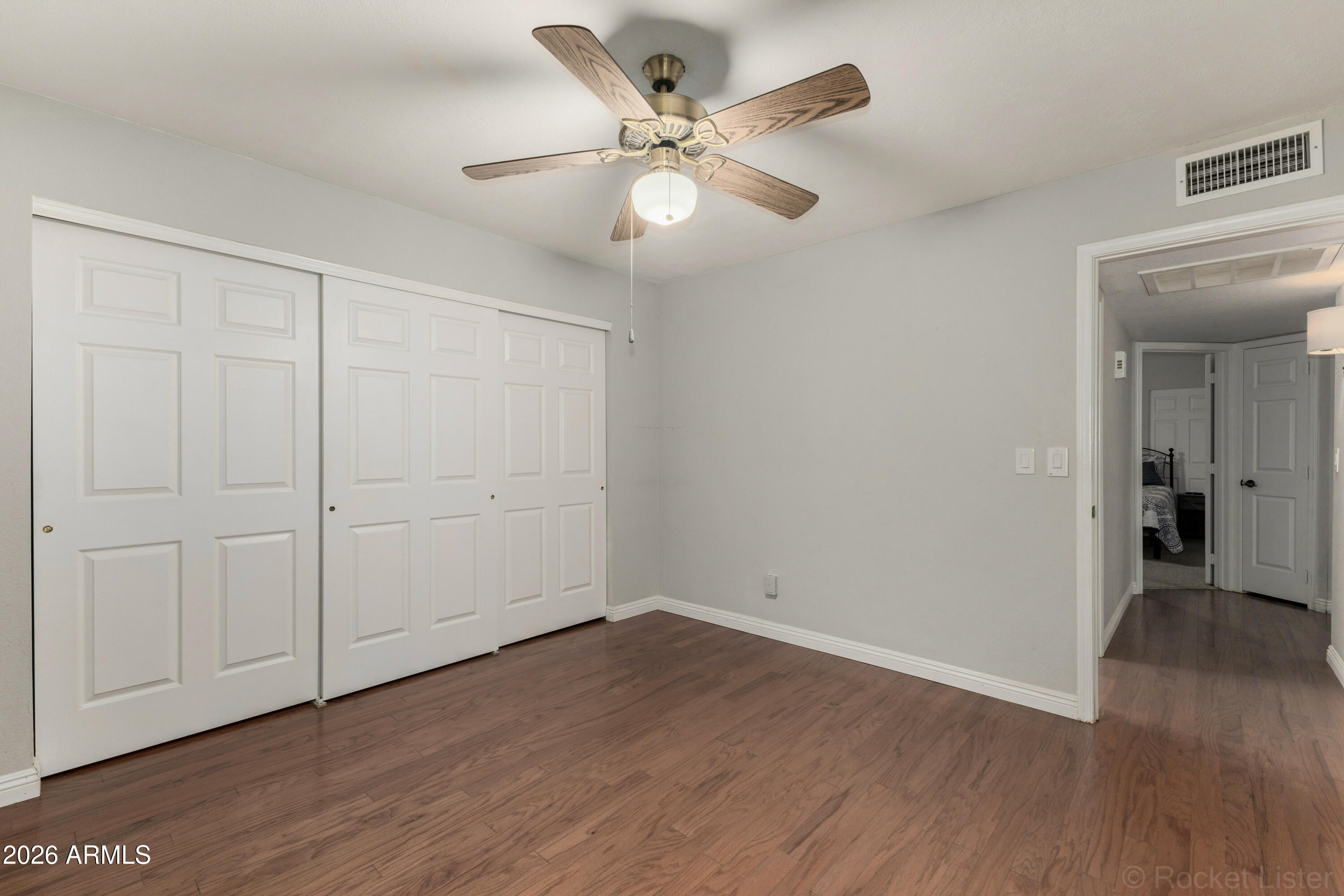 542 South Higley Road, Unit 61 Mesa, AZ 85206 - Photo 13 of 33 a view of an empty room with wooden floor