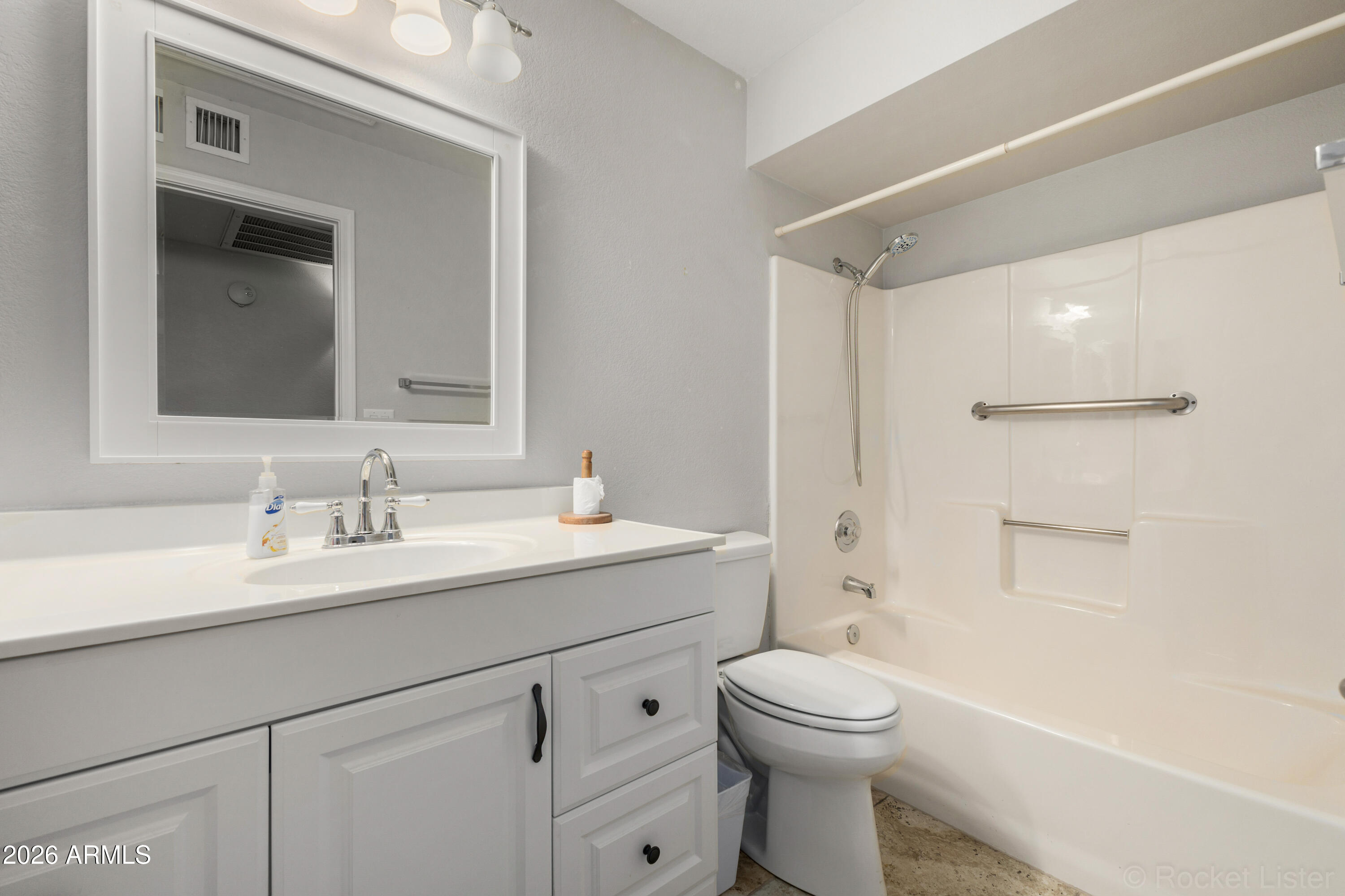 542 South Higley Road, Unit 61 Mesa, AZ 85206 - Photo 14 of 33 a bathroom with a toilet a sink a mirror a shower a vanity and window