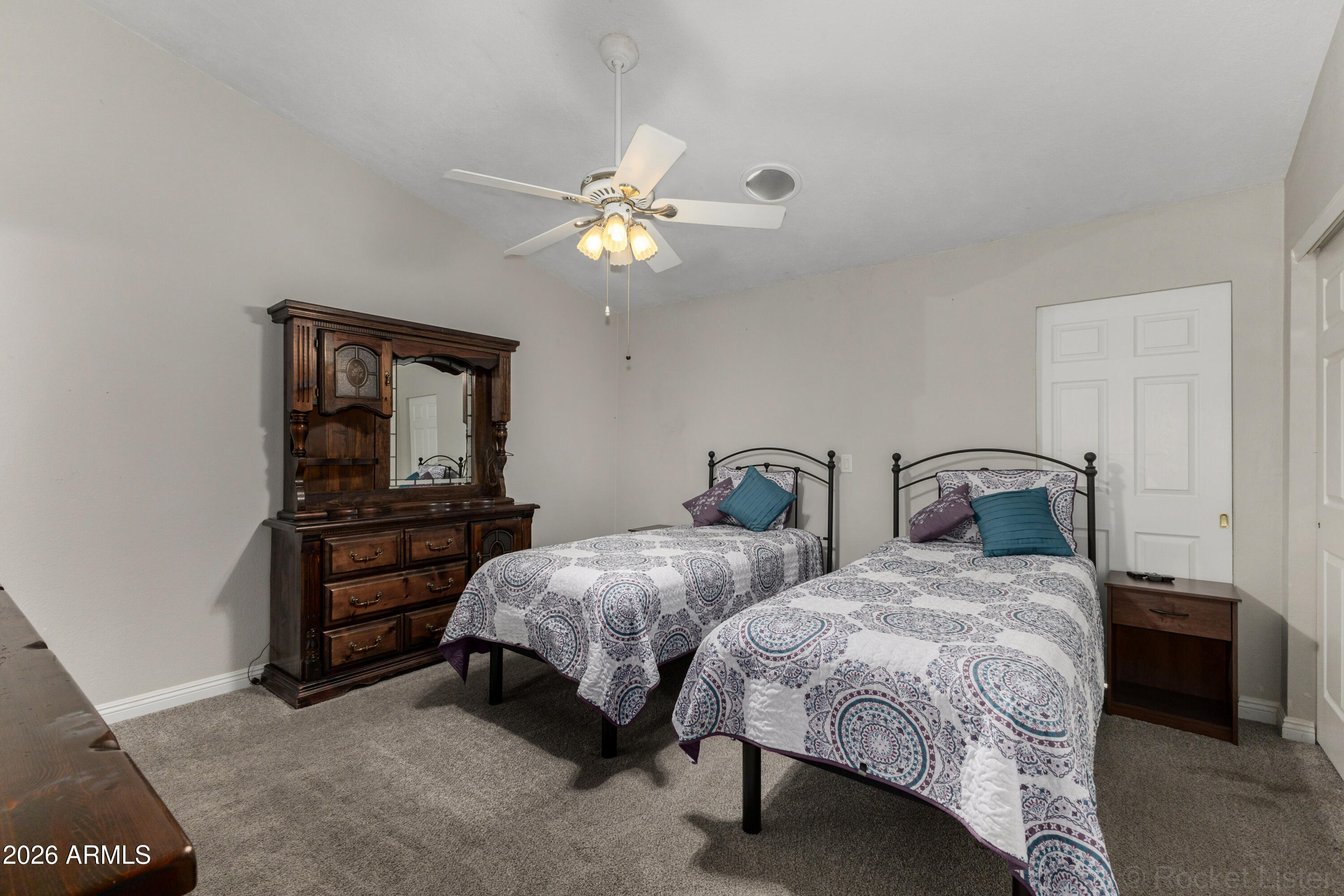 542 South Higley Road, Unit 61 Mesa, AZ 85206 - Photo 15 of 33 a bedroom with two beds and a chandelier
