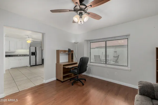 a workspace with wooden floor and a ceiling fan