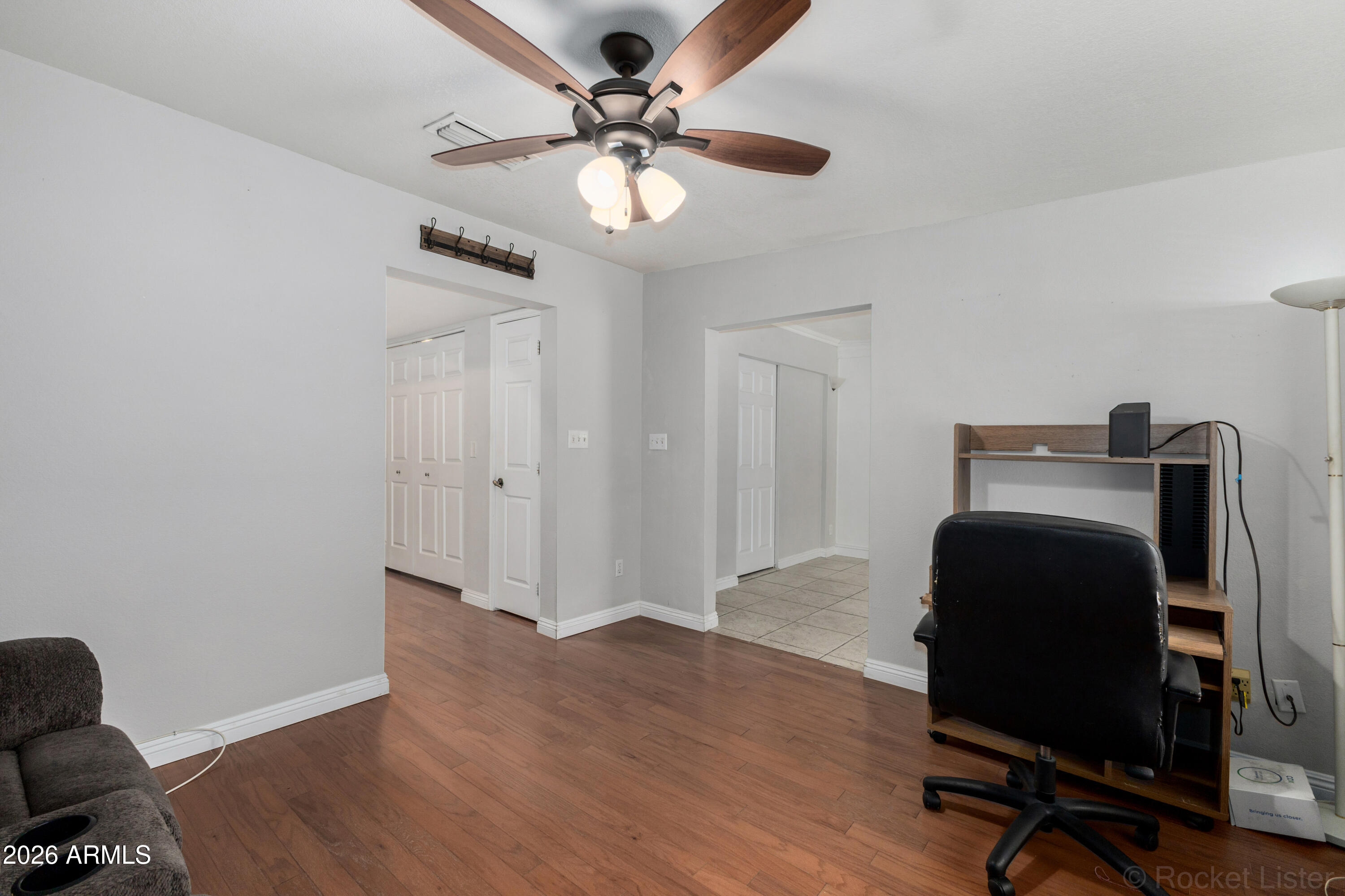 542 South Higley Road, Unit 61 Mesa, AZ 85206 - Photo 20 of 33 a workspace with wooden floor and a ceiling fan