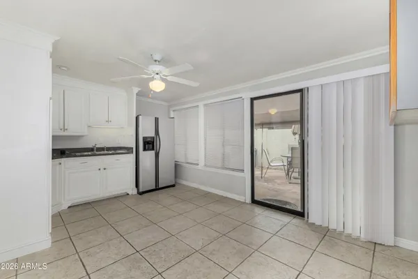 a view of a kitchen with a sink and a refrigerator