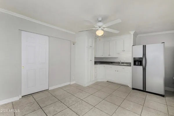 a kitchen with white cabinets and white appliances