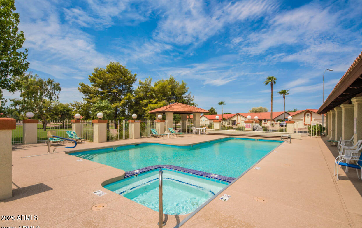 542 South Higley Road, Unit 61 Mesa, AZ 85206 - Photo 32 of 33 a view of a swimming pool with an outdoor seating