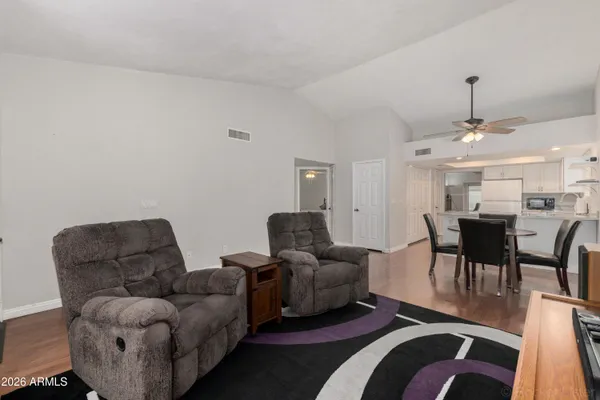 a living room with furniture and wooden floor