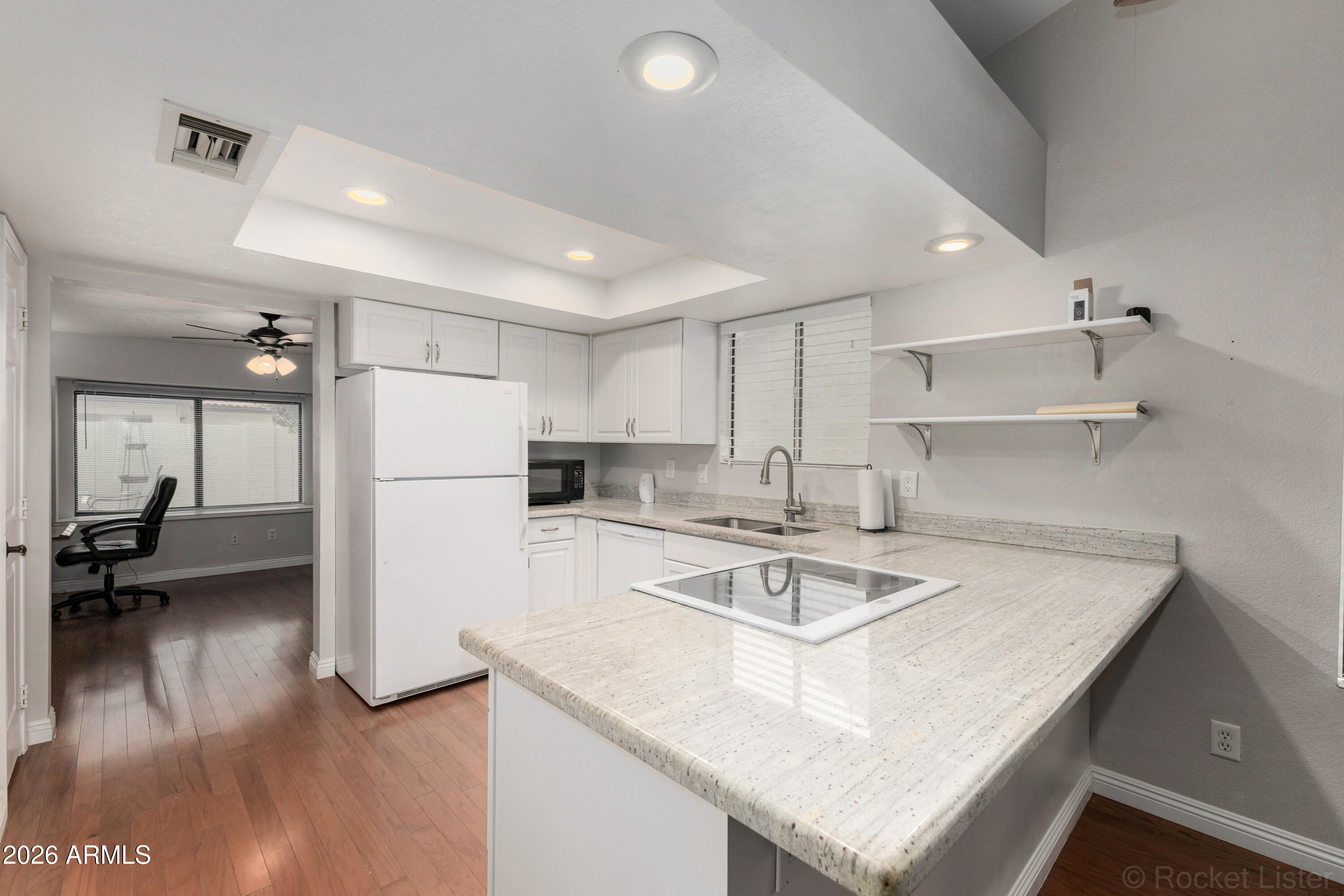 542 South Higley Road, Unit 61 Mesa, AZ 85206 - Photo 9 of 33 a kitchen with a table chairs refrigerator and cabinets
