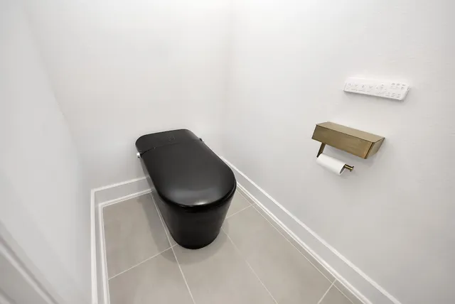 a large white bathroom with a double vanity sink a mirror and a bathtub