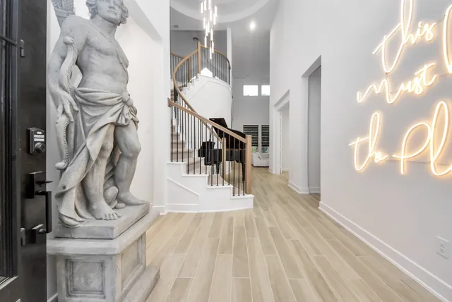 a view of entryway and hall with wooden floor