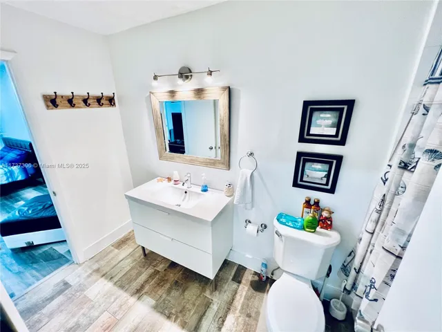 a white bath tub sitting next to a white toilet and a sink