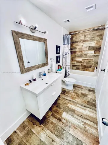 a bathroom with a sink a mirror and a bathtub