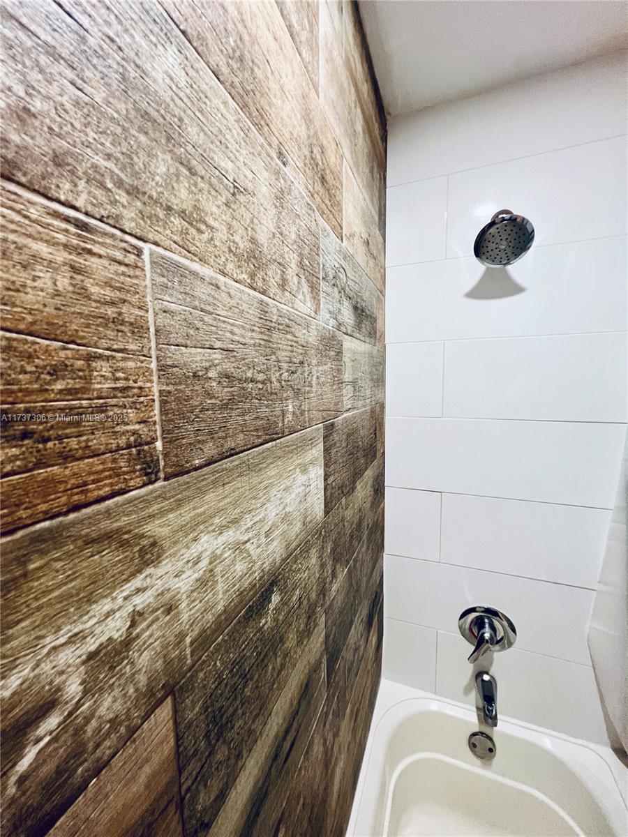 13499 Biscayne Boulevard, Unit PH1705 North Miami, FL 33181 - Photo 22 of 37 a bathroom with a sink and a shower