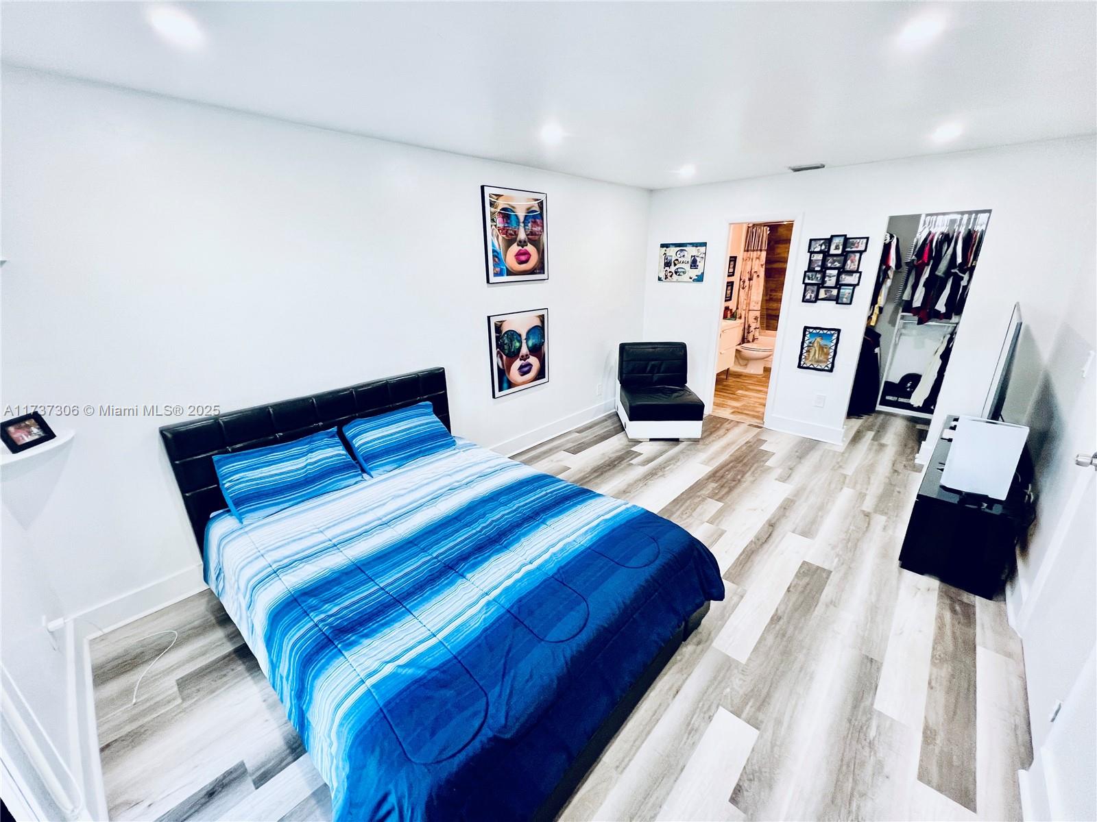 13499 Biscayne Boulevard, Unit PH1705 North Miami, FL 33181 - Photo 23 of 37 a bedroom with a bed a window and wall