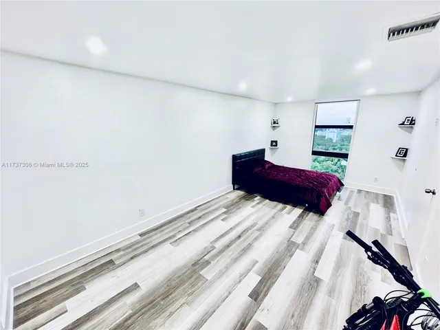 a bedroom with a large bed and a dresser