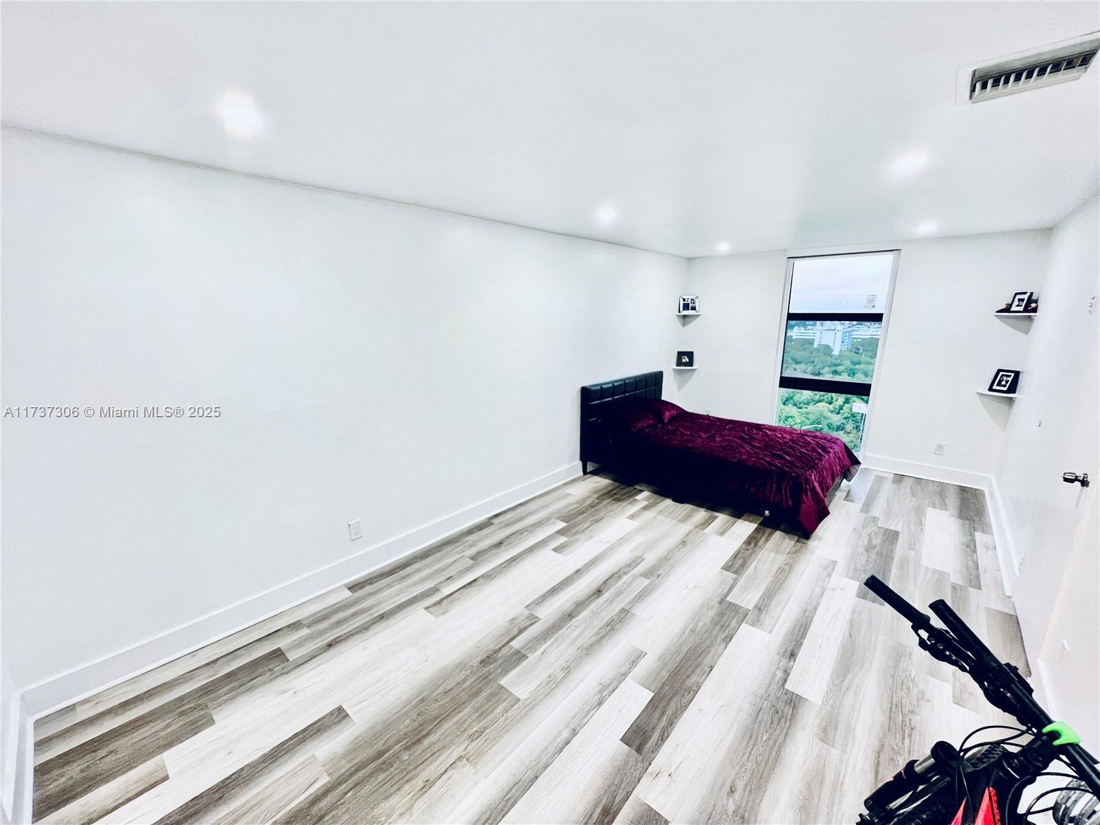 13499 Biscayne Boulevard, Unit PH1705 North Miami, FL 33181 - Photo 27 of 37 a bedroom with a large bed and a dresser