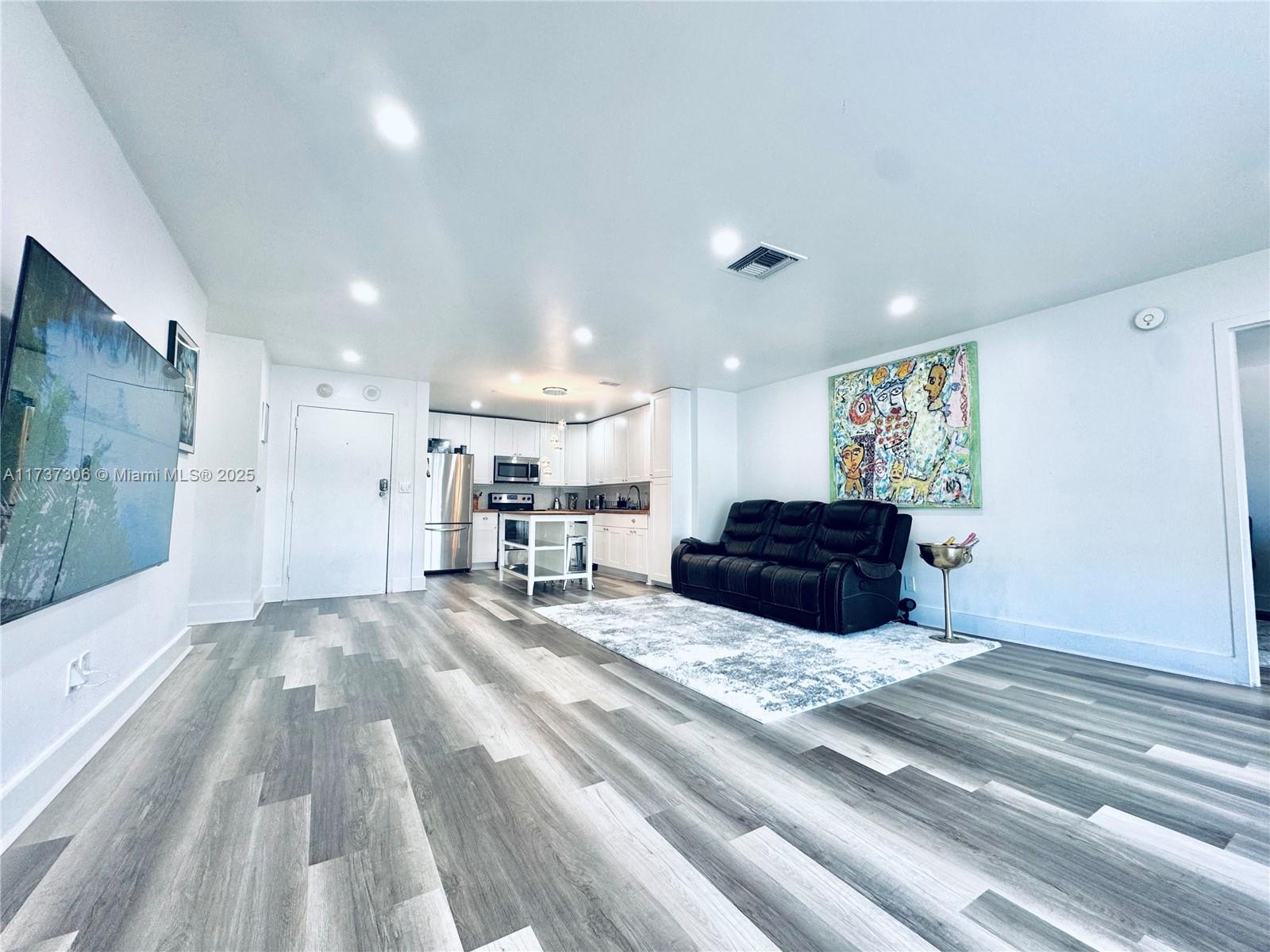 13499 Biscayne Boulevard, Unit PH1705 North Miami, FL 33181 - Photo 4 of 37 a kitchen with a sink stove and refrigerator