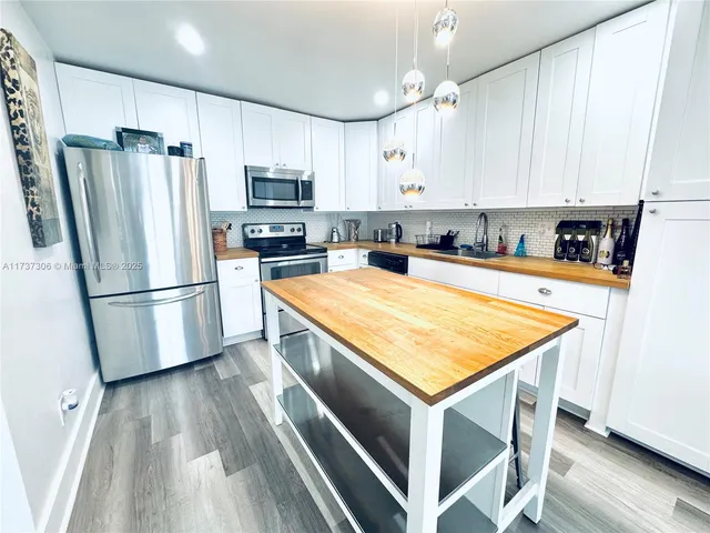 a kitchen with wooden cabinets and stainless steel appliances