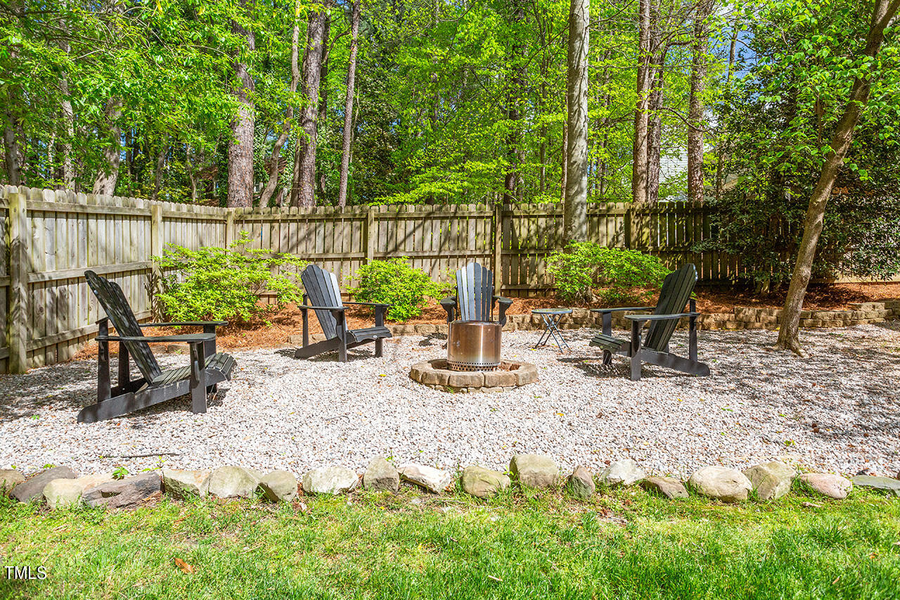 2520 Harptree Court Raleigh, NC 27613 - Photo 12 of 69 a view of a patio with table and chairs potted plants and large tree