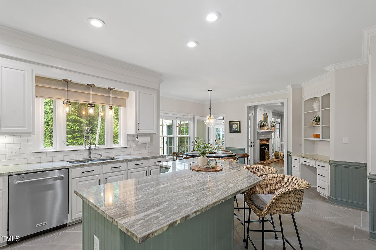 2520 Harptree Court Raleigh, NC 27613 - Photo 22 of 69 a kitchen with granite countertop lots of counter top space and living room