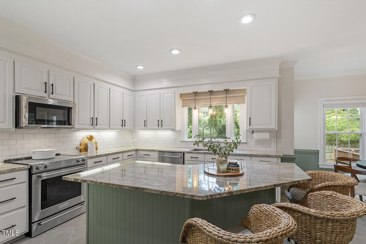 2520 Harptree Court Raleigh, NC 27613 - Photo 23 of 69 a kitchen with stainless steel appliances granite countertop a sink a stove and a microwave