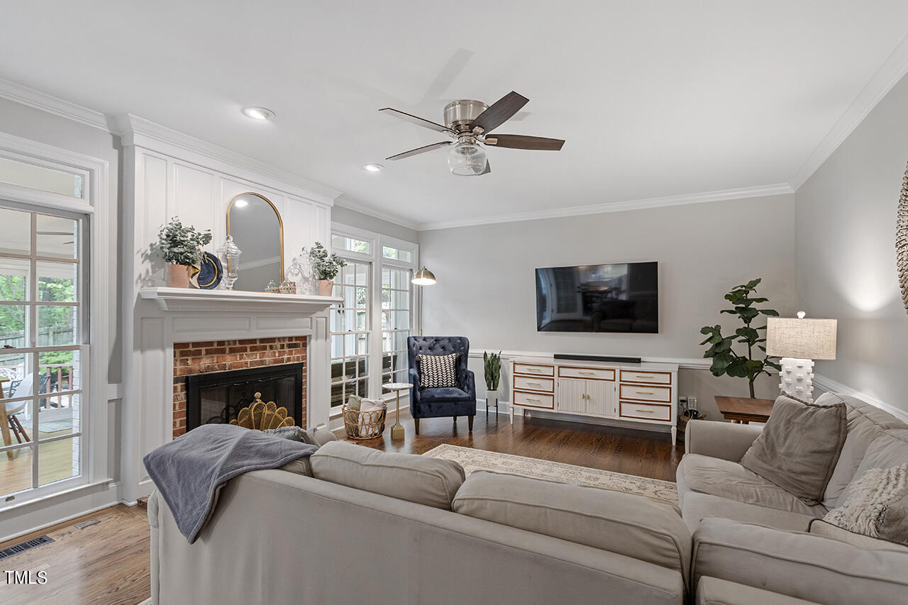 2520 Harptree Court Raleigh, NC 27613 - Photo 28 of 69 a living room with furniture a fireplace and a flat screen tv