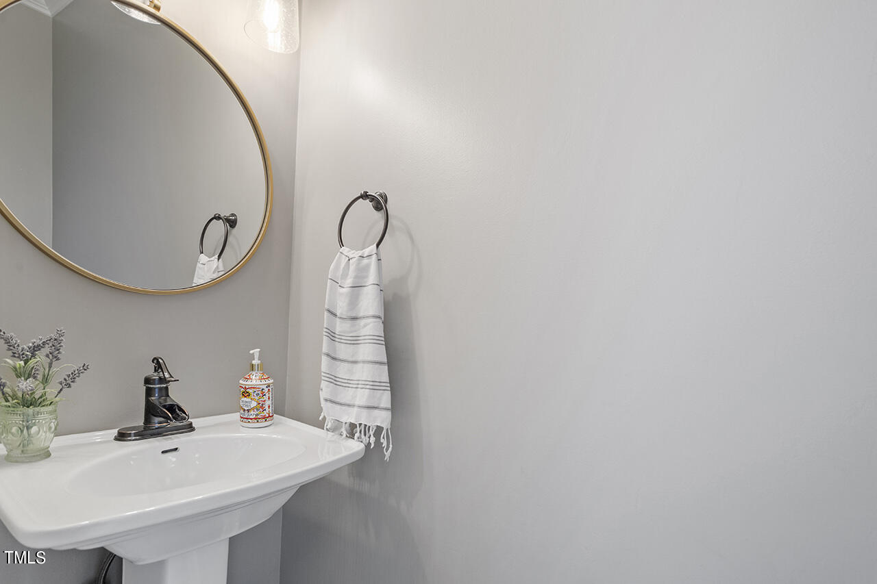 2520 Harptree Court Raleigh, NC 27613 - Photo 34 of 69 a bathroom with a sink and a mirror