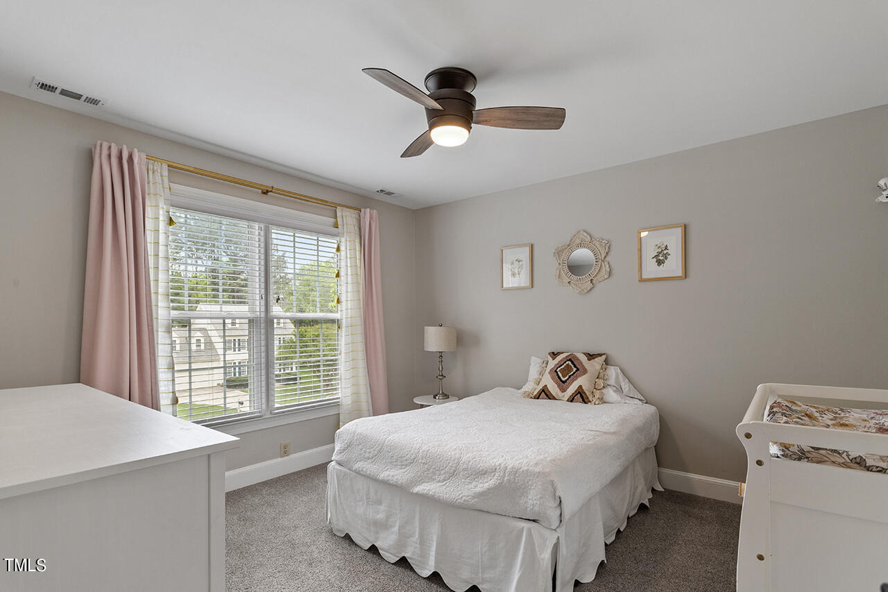 2520 Harptree Court Raleigh, NC 27613 - Photo 36 of 69 a bedroom with a bed and a window