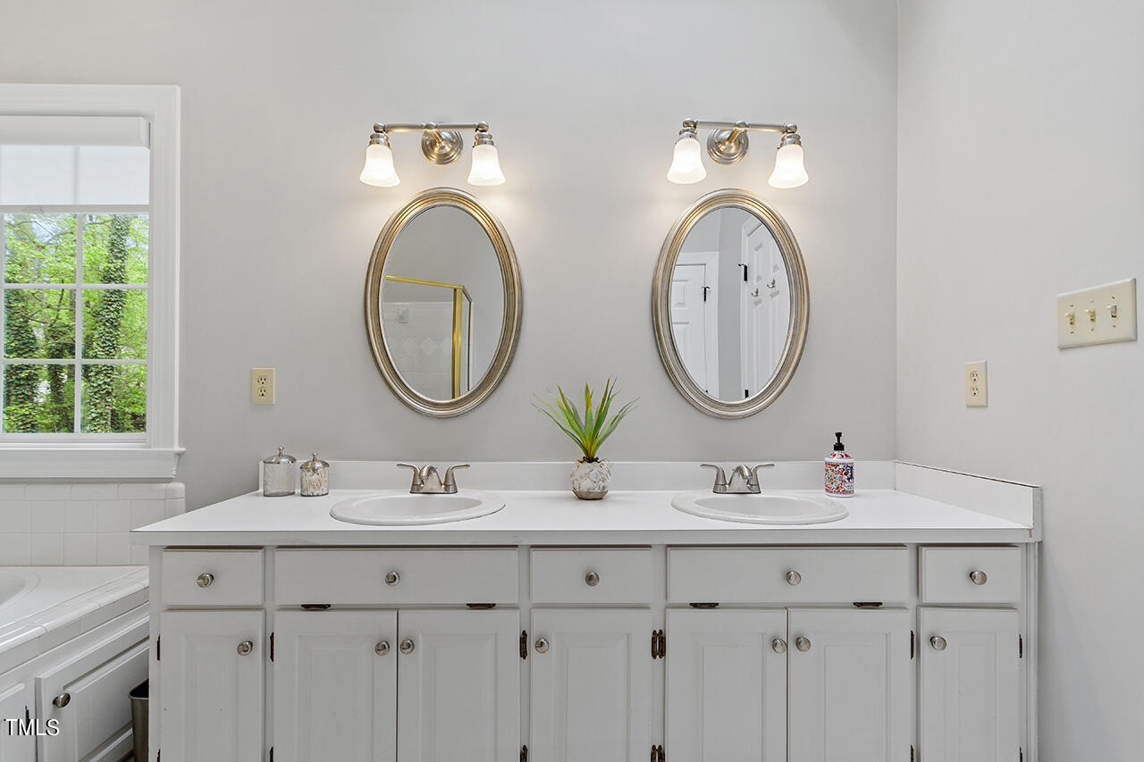 2520 Harptree Court Raleigh, NC 27613 - Photo 43 of 69 a bathroom with a sink and a mirror