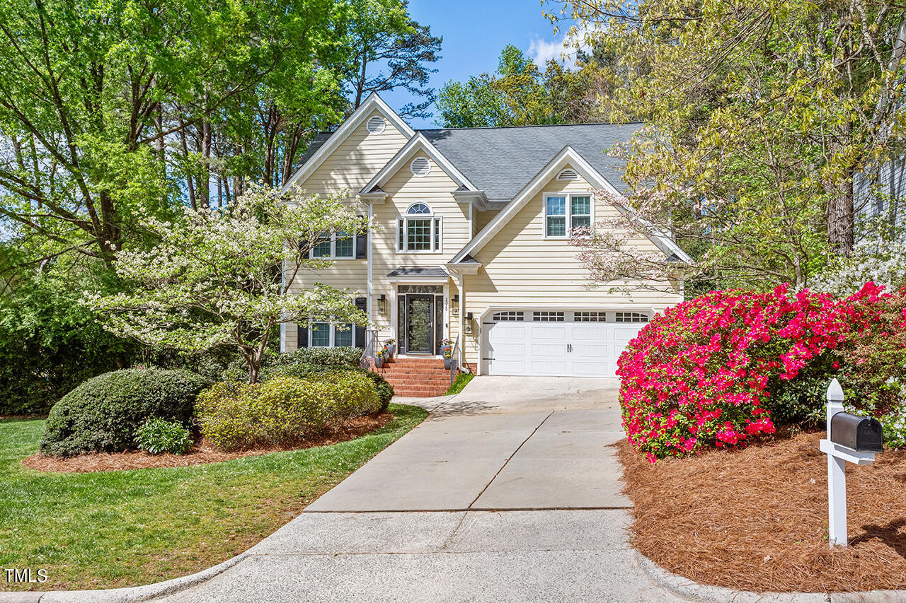 2520 Harptree Court Raleigh, NC 27613 - Photo 5 of 69 a view of a white house with a small yard and potted plants