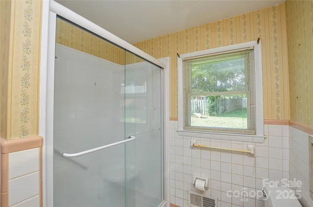 a bathroom with a window and a shower